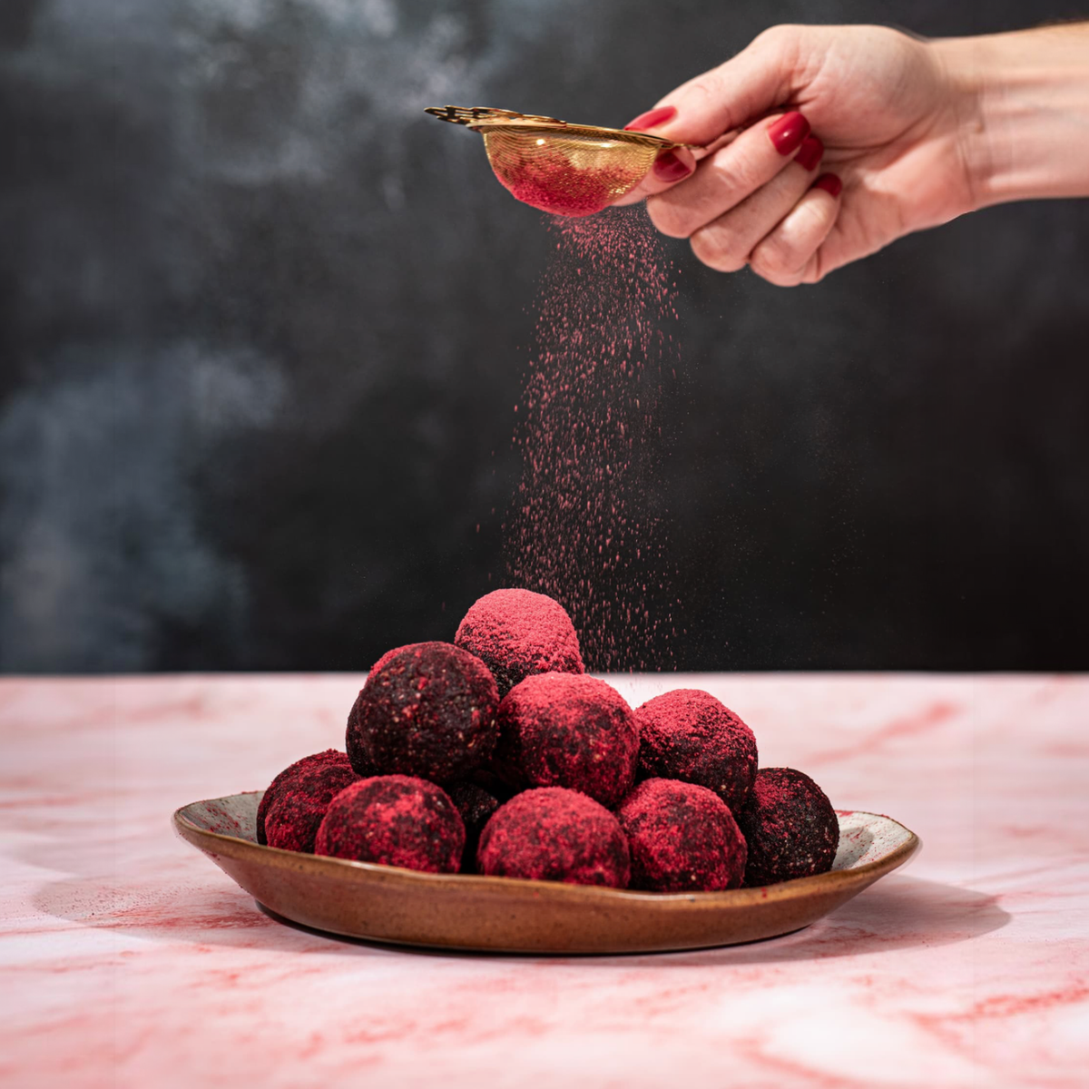 Raspberry Choc Bomb Amazeballs dusted with raspberry powder