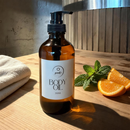 Genki Joy Body Oil 200ml on a timber bench with peppermint and orange