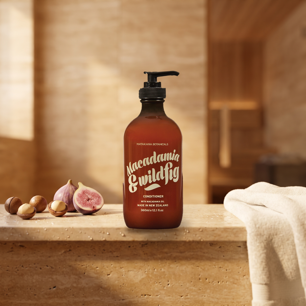 Macadamia & Wild Fig Conditioner on a stone ledge with fig and macadamia