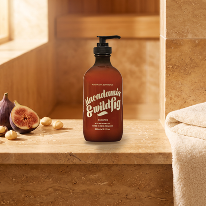 Macadamia & Wild Fig Shampoo on a stone ledge with fig and macadamia